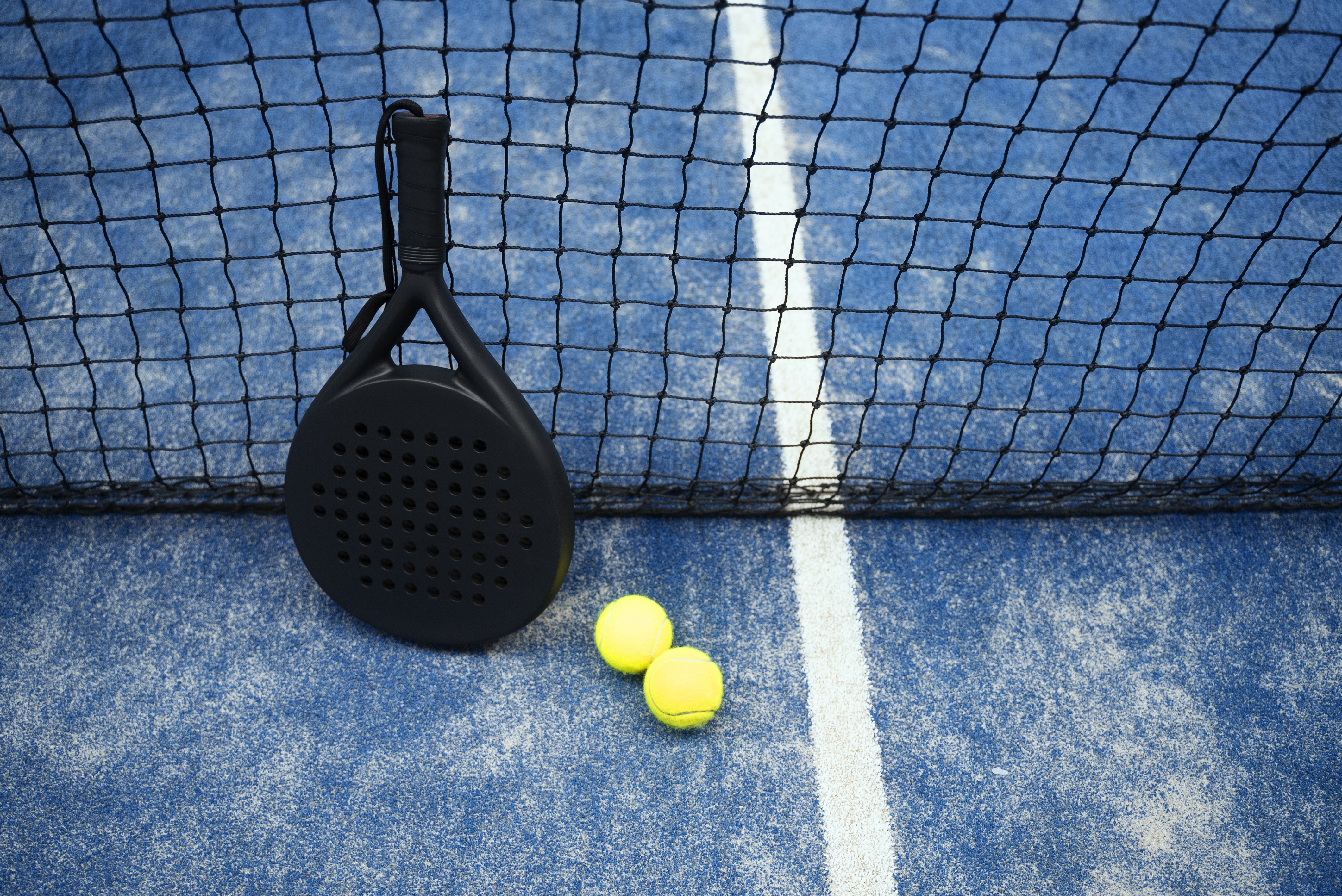 Padel racket and balls close-up